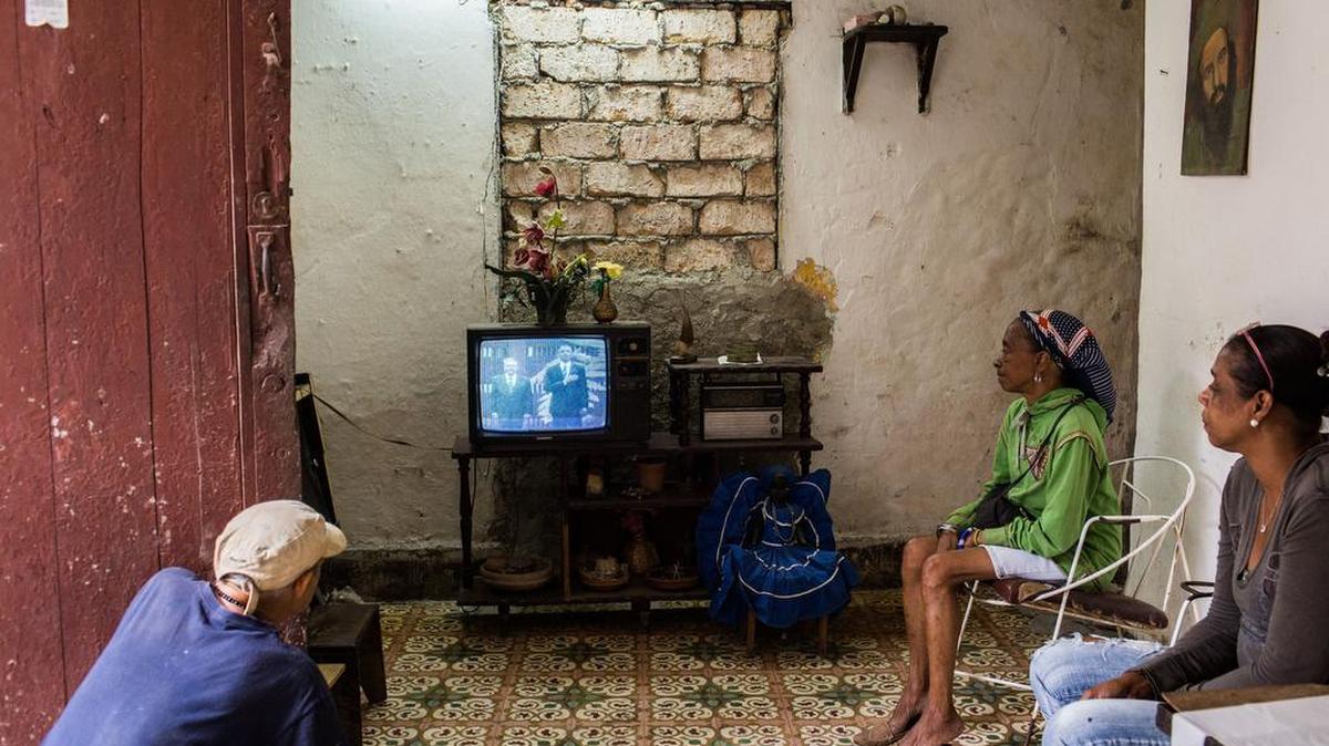 Anisia Cuesta Ordaz, 46, Irma Ostia La Cruz, 58, (in the middle) and some of her neighbors watch TV as President Barack Obama was received in Havana by Raul Castro on March 21, 2016.