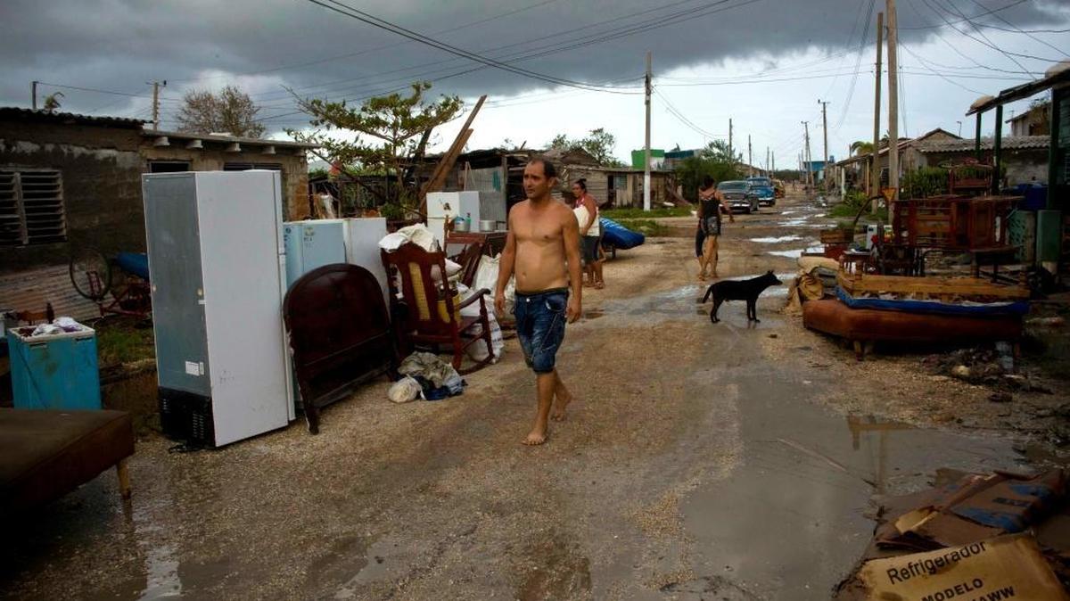A man walks among the belongings of those affected by Hurricane Irma in Isabela de Sagua, Cuba, Monday, Sept. 11, 2017. The powerful storm ripped roofs off houses, collapsed buildings and flooded hundreds of thousands of coastline after cutting a trail of destruction across the Caribbean.