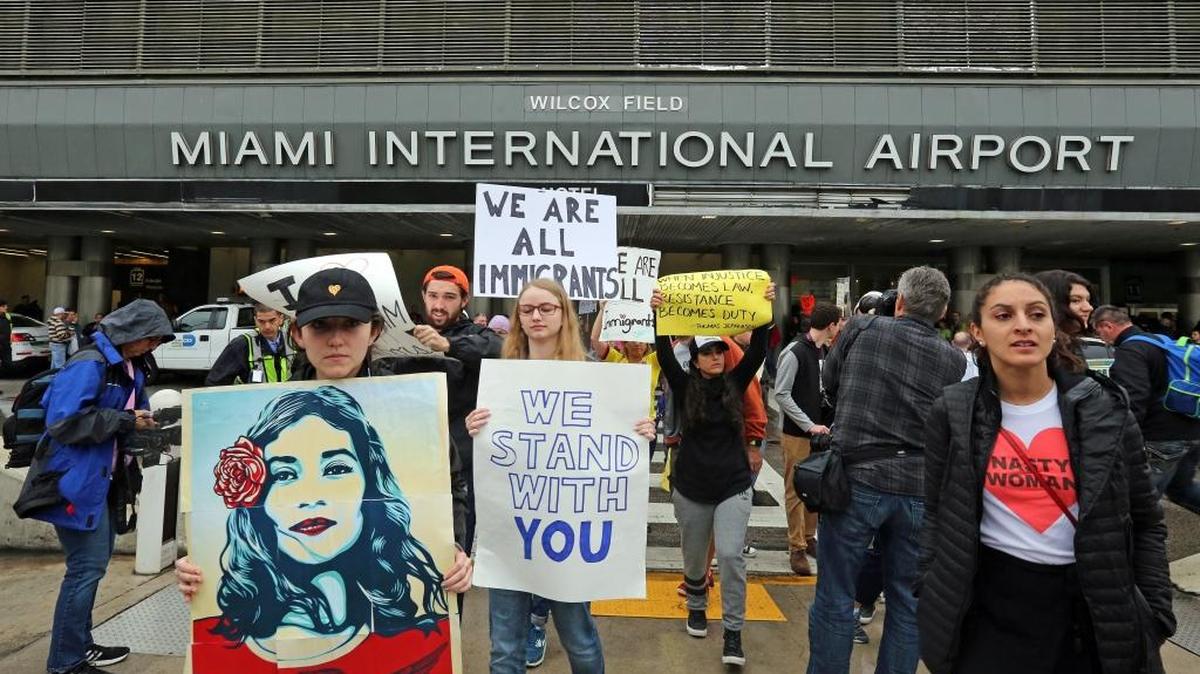 Around 300 protesters march at Miami International Airport protesting President Trump's immigration order.