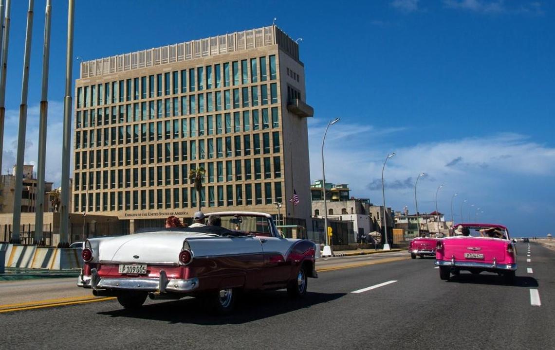 Classic cars carrying tourists pass the U.S. Embassy in Havana, Cuba. Doctors treating embassy victims of mysterious attacks in Cuba have discovered brain abnormalities in some patients. The U.S. State Department is still investigating the cause and source of the incidents.