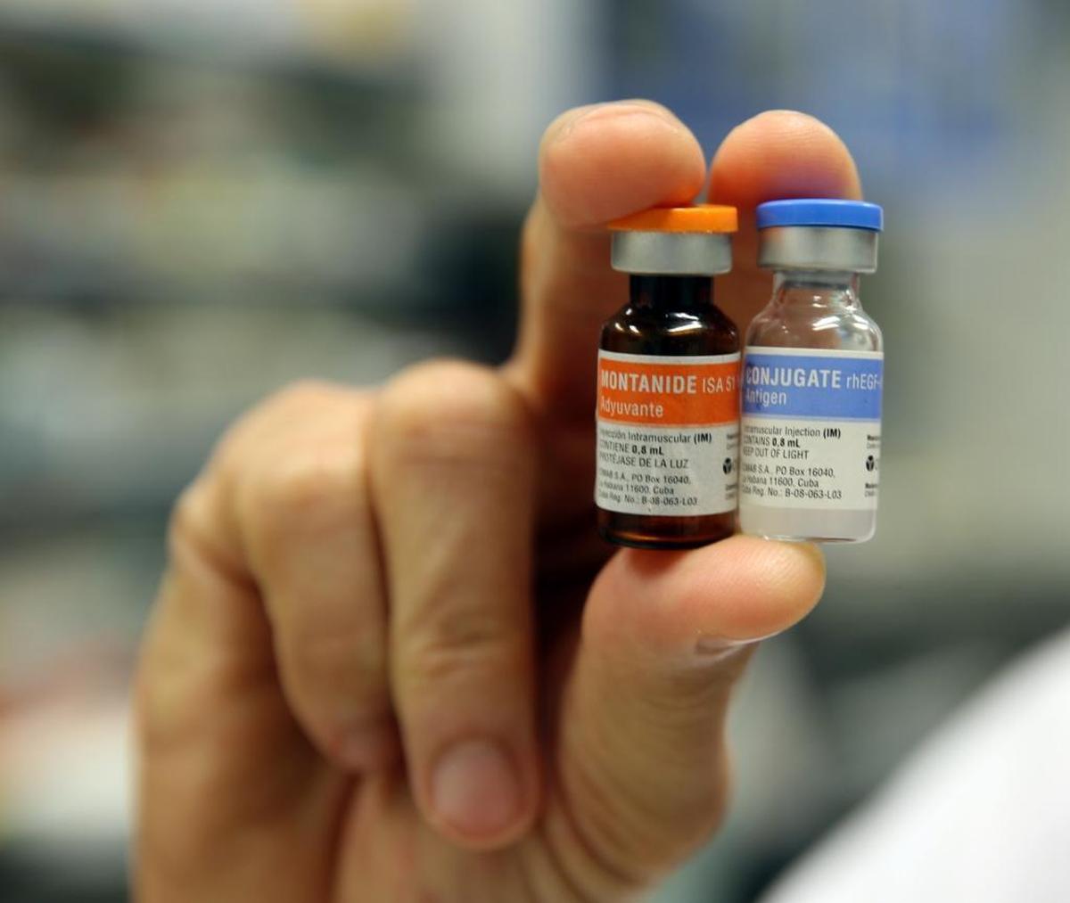 Dr. Pedro Camilo Rodríguez, with the Center for Molecular Immunology in Havana, Cuba, holds vials of a vaccine that he helped develop to treat non-small-cell lung carcinoma.