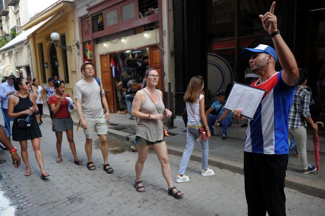 Cuban visitors and their guide walk along a street in Havana on June 15, 2017. That was the day before President Donald Trump announced a new policy that will bar individual people-to-people travel to Cuba.