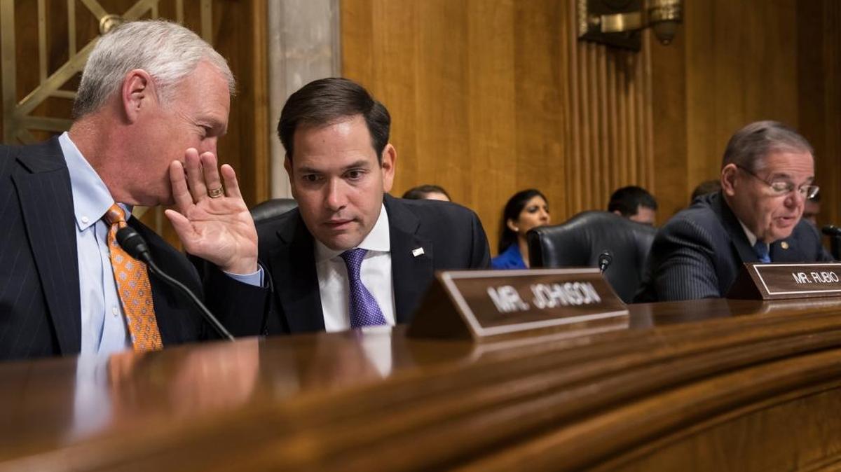Sen. Marco Rubio, R-Fla., center, confers with Sen. Ron Johnson, R-Wisc., left, as Sen. Bob Menendez, D-N.J., far right, speaks as the Senate Foreign Relations Subcommittee on the Western Hemisphere examines attacks on American diplomats in Havana.