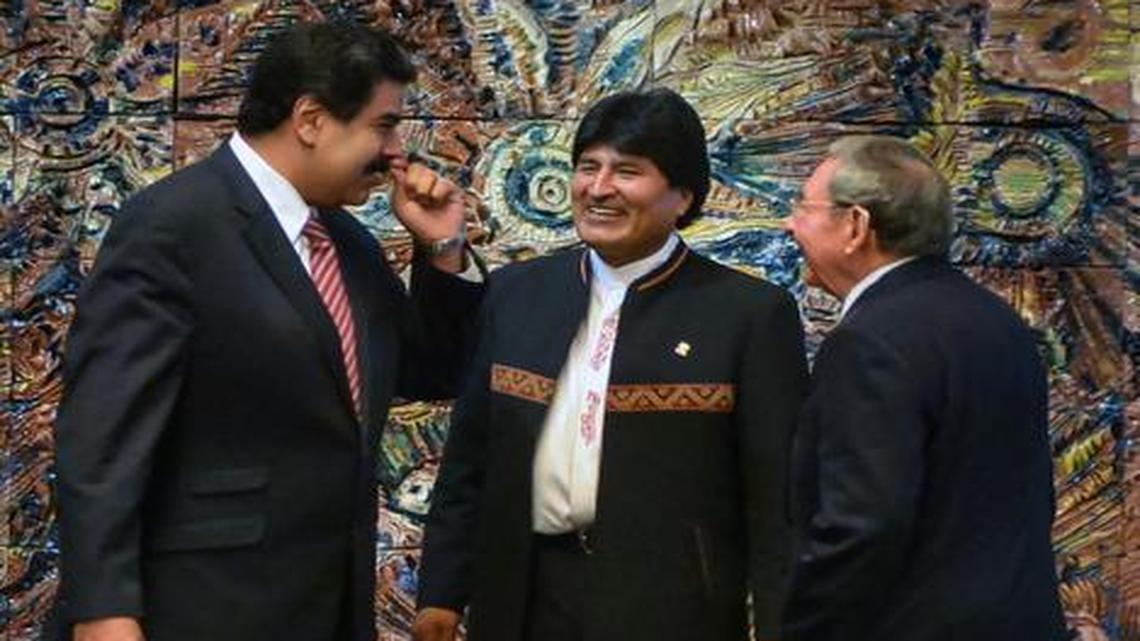 
(L-R) Venezuelan President Nicolas Maduro, Bolivian President Evo Morales and Cuban President Raul Castro prepare for the official photo of the XIII Bolivarian Alliance for the Peoples of Our America (ALBA) Summit in Havana on December 14, 2014. The economic problems of ally Venezuela may have prompted Cuba to seek closer ties with the U.S.
