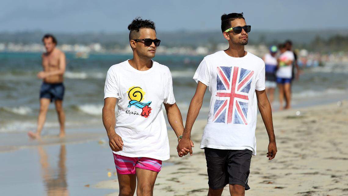Abel Gutiérrez Llanez, 32, left, and his partner, Daniel Verdecia Nápoles, 18, pose at Mi Cayito beach, a meeting place in Havana, Cuba, for the gay community.
