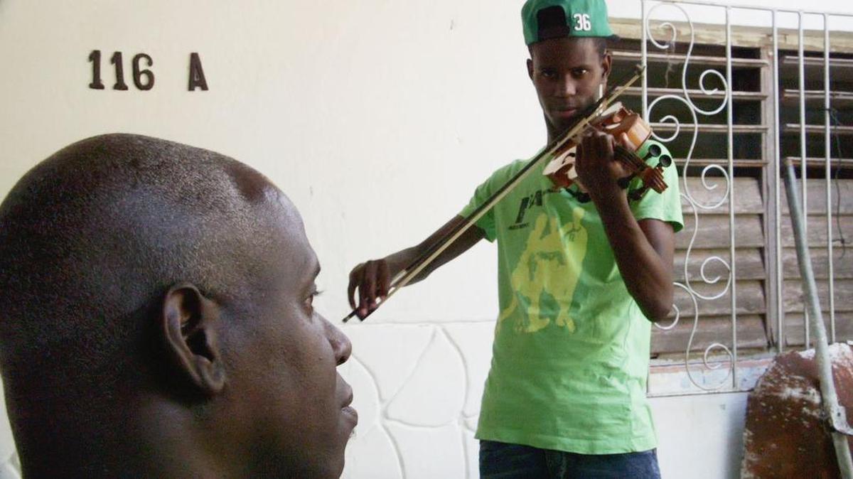 José Osvaldo Hunter Hernández practices the violin.