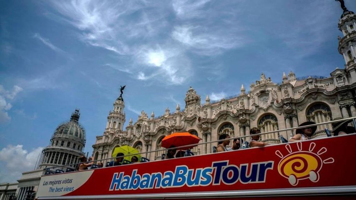 Tourists ride a tour bus in front of the Capitolio in Havana in June 2017.