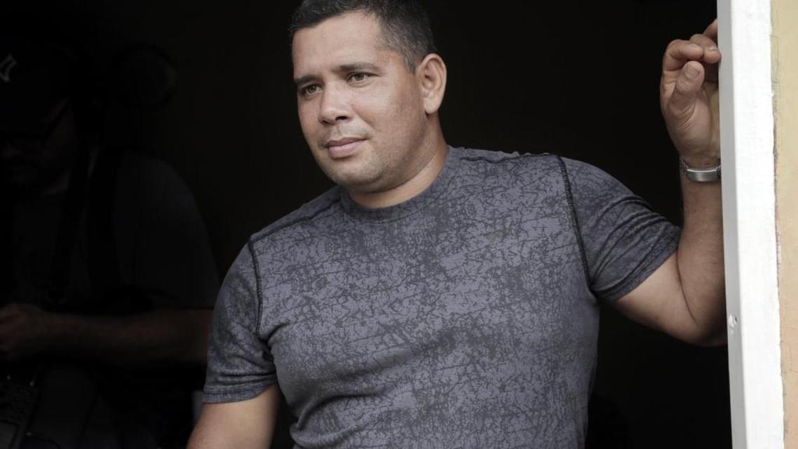 Yoendry Batista stands in the front door of a house he rents with his wife Yudenny Sao Labrada in Panama City, Panama.