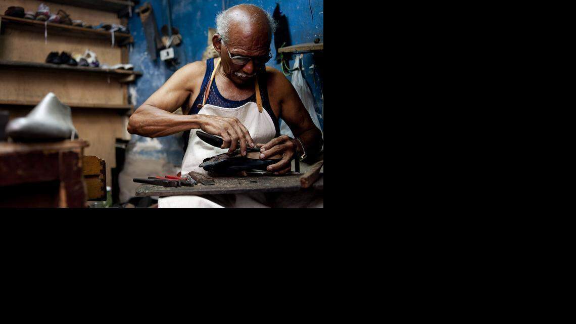 
A shoe repairman fixes a pair of shoes at a shop in Havana, Cuba. Footwear is one of the products that private Cuban entrepreneurs will be able to sell in the United States under new rules released by the State Department. 
