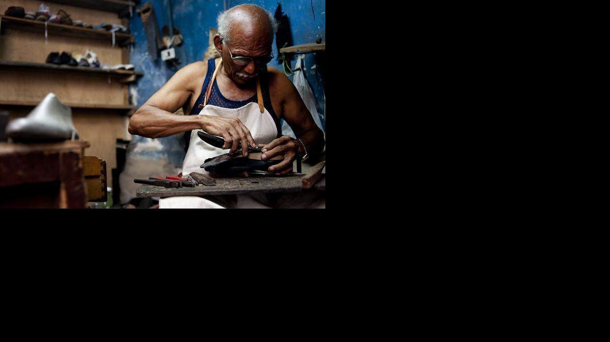
A shoe repairman fixes a pair of shoes at a shop in Havana, Cuba. Footwear is one of the products that private Cuban entrepreneurs will be able to sell in the United States under new rules released by the State Department. 

