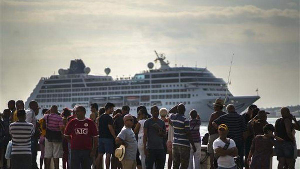 People watch Carnival's Adonia cruise ship arrive from Miami, in Havana, Cuba, Monday, May 2, 2016. The Adonia's arrival is the first step toward a future in which thousands of ships a year could cross the Florida Straits, long closed to most U.S.-Cuba traffic due to tensions that once brought the world to the brink of nuclear war.