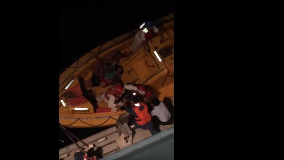 A screengrab from a YouTube video reportedly taken on the Brilliance of the Seas Friday, March 18, 2016 shows crews members helping to rescue Cuban rafters.