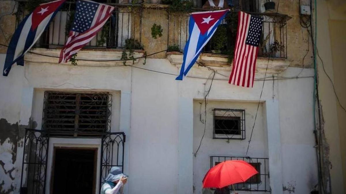 Cuban and U.S. flags hang from a balcony in Havana, Cuba.