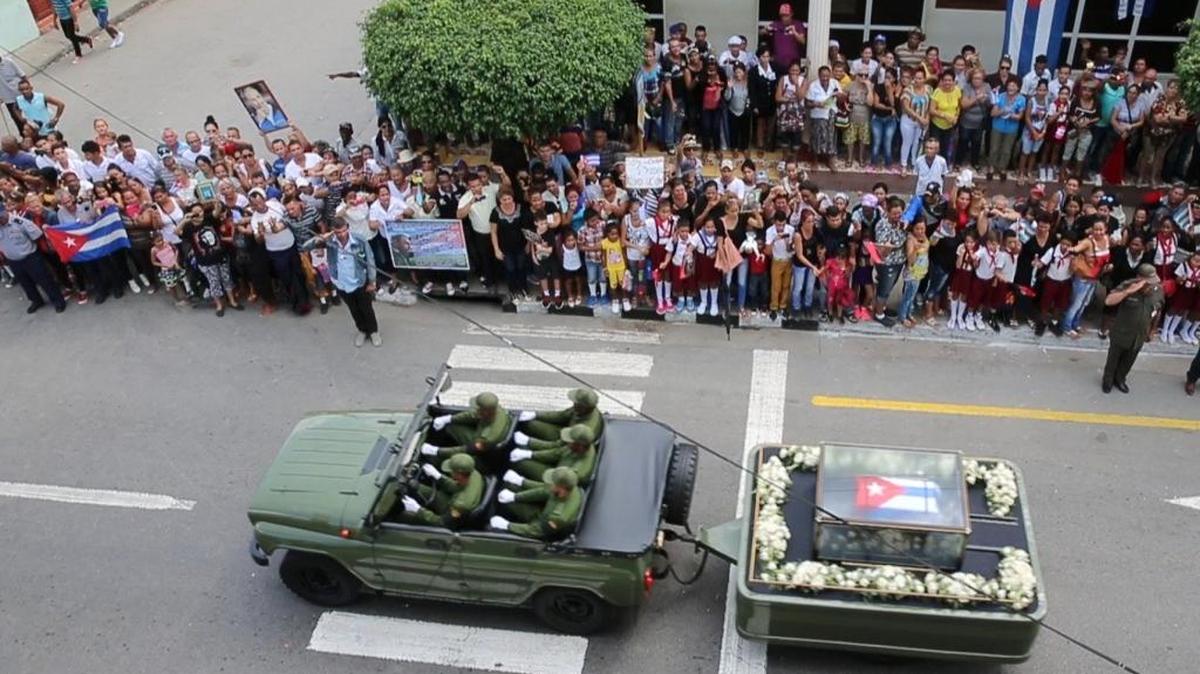 Cuban's line the street as Fidel Castro's ashes pass along the main road through Las Tunas, Cuba.
