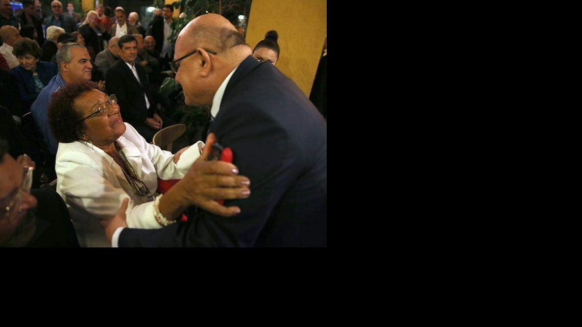 
Dagoberto Valdes, greets Reina Luisa Tamayo, mother of Cuban dissident Orlando Zapata Tamayo, during a gathering with exiles at Cuba Ocho cultural center in Little Havana to discuss the future of Cuba.
