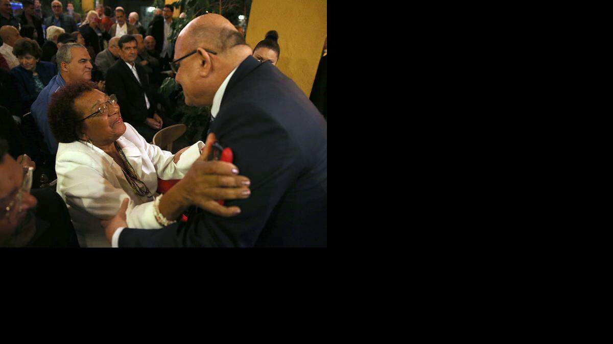 
Dagoberto Valdes, greets Reina Luisa Tamayo, mother of Cuban dissident Orlando Zapata Tamayo, during a gathering with exiles at Cuba Ocho cultural center in Little Havana to discuss the future of Cuba.
