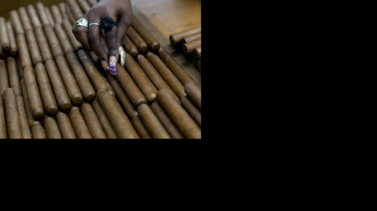 
A worker selects cigars at the H. Upmann cigar factory in Havana, Cuba. Cigars are among the items not eligible for import under the new rules.
