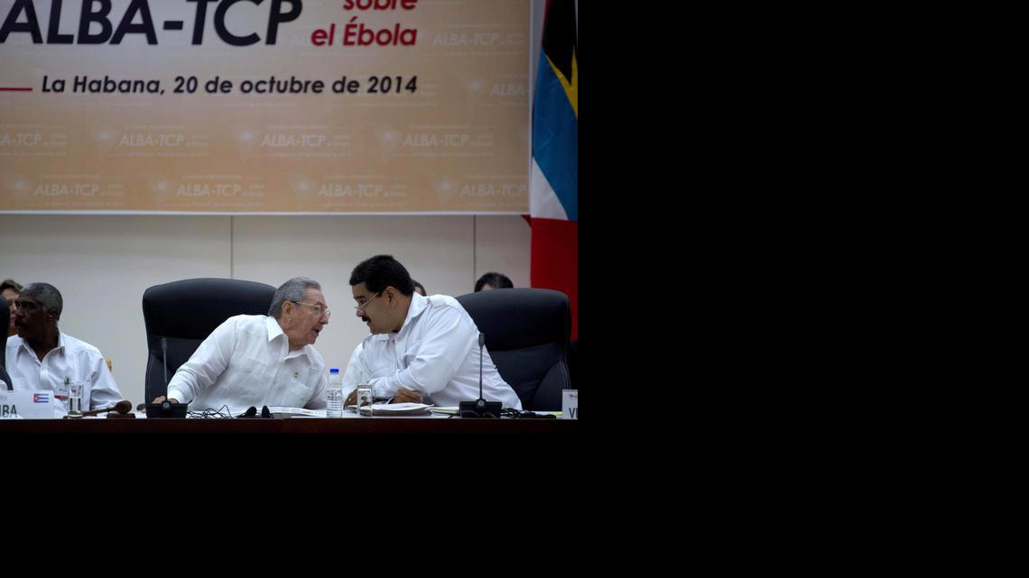 
Cuba's President Raul Castro, center, leans over to speak with Venezuela's President Nicolas Maduro, during an ALBA summit in Havana, Cuba, Monday, Oct. 20, 2014. The meeting in Havana was called by Maduro with the stated objective of preventing the spread of Ebola. Cuba is sending nearly 400 doctors to Liberia, Guinea and Sierra Leone, the largest contribution by any single country. Castro said, "Cuba is willing to work shoulder to shoulder with all other countries, including the United States." 
