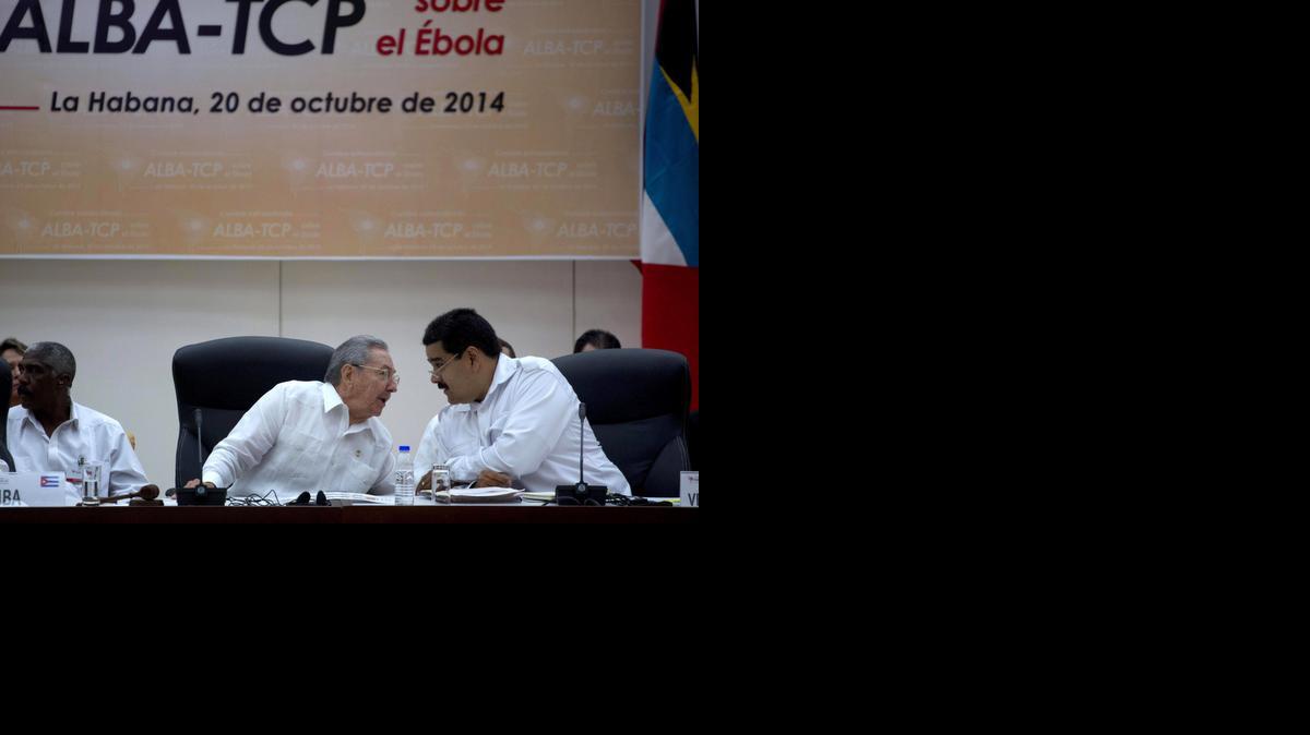 
Cuba's President Raul Castro, center, leans over to speak with Venezuela's President Nicolas Maduro, during an ALBA summit in Havana, Cuba, Monday, Oct. 20, 2014. The meeting in Havana was called by Maduro with the stated objective of preventing the spread of Ebola. Cuba is sending nearly 400 doctors to Liberia, Guinea and Sierra Leone, the largest contribution by any single country. Castro said, "Cuba is willing to work shoulder to shoulder with all other countries, including the United States." 
