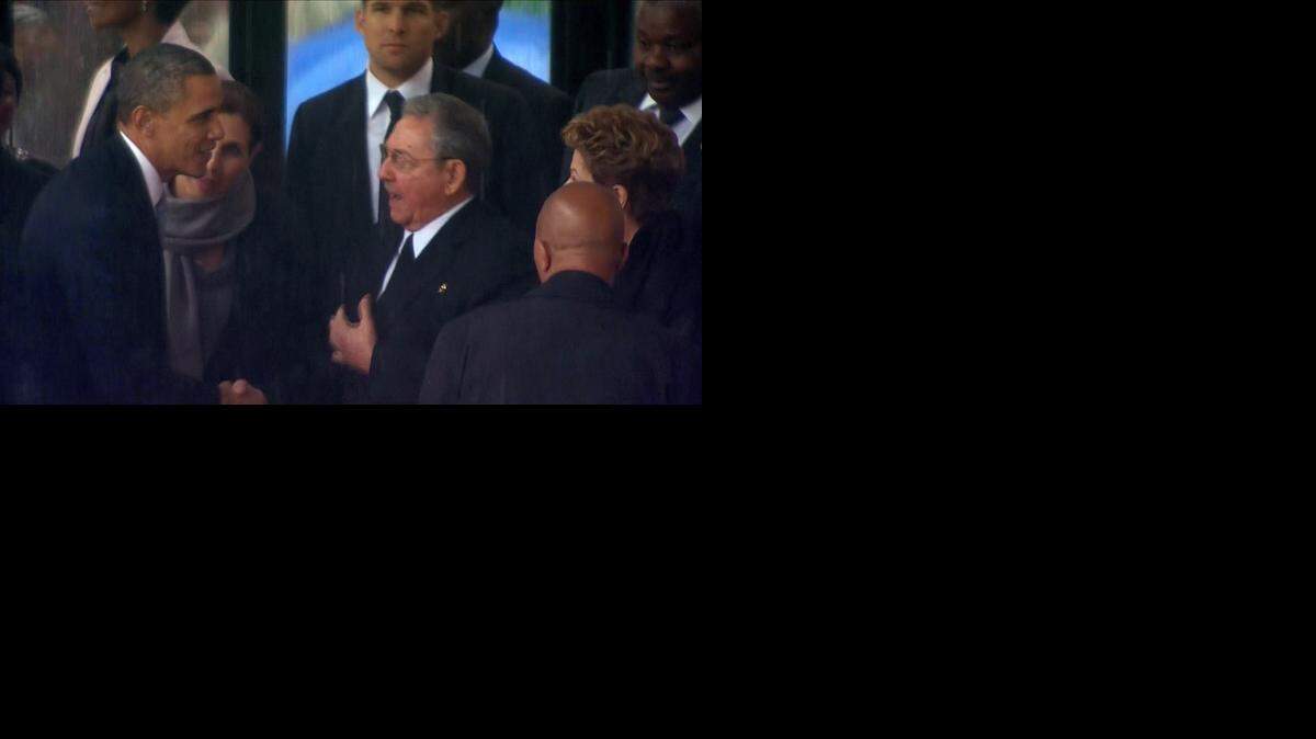 
SEE YOU IN PANAMA: President Barack Obama and Cuban leader Raúl Castro briefly shook hands at a memorial service for Nelson Mandela in 2013. They are to meet again in Panama later this week during the seventh Summit of the Americas.

