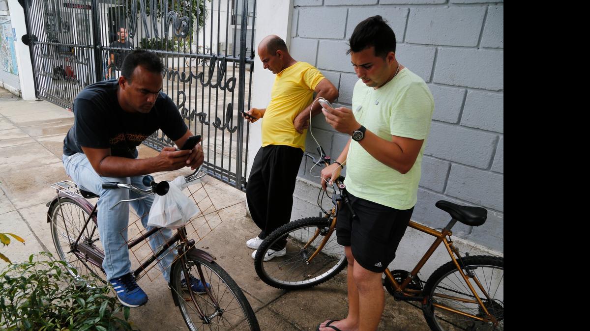 
People stand in front of a center run by famed artist Kcho, to use the free Wi-Fi network, in Havana, Cuba, earlier this year. State-run telecom Etecsa approved the move in a small but unprecedented loosening of Cuba's strict Internet regulations. The government said this week that it is further enhancing Cuba’s Wi-Fi network.
