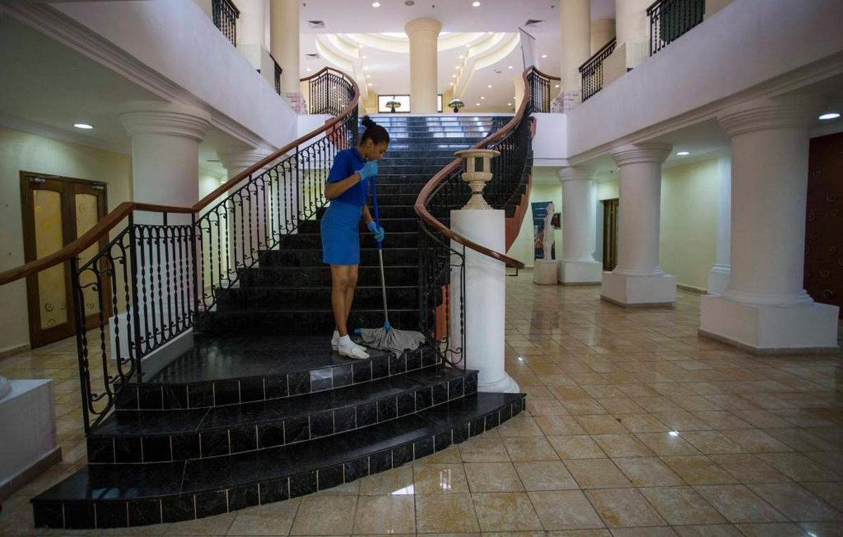 A worker cleans stairs beside the lobby of the Four Points by Sheraton Hotel in Havana, Cuba. American hotel giant Starwood has rebranded the hotel and is managing it in a venture with the Cuban military.