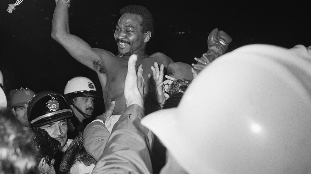 A jubilant Jose ‘Mantequilla’ Napoles waves a hat high in the air as he is hoisted onto the shoulders of fight fans in Los Angeles April 18, 1969, after beating Curtis Cokes of Dallas, Texas.