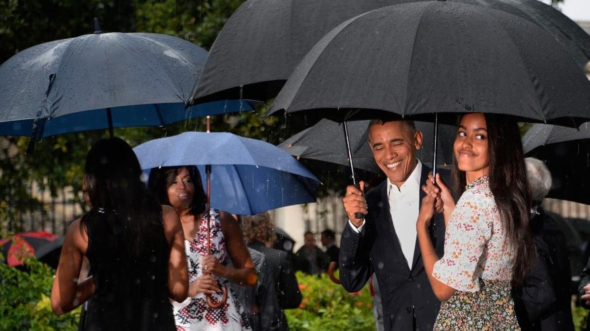 President Barack Obama, First Lady Michelle Obama and daughters Malia and Sasha walk in downtown Old Havana on Sunday.