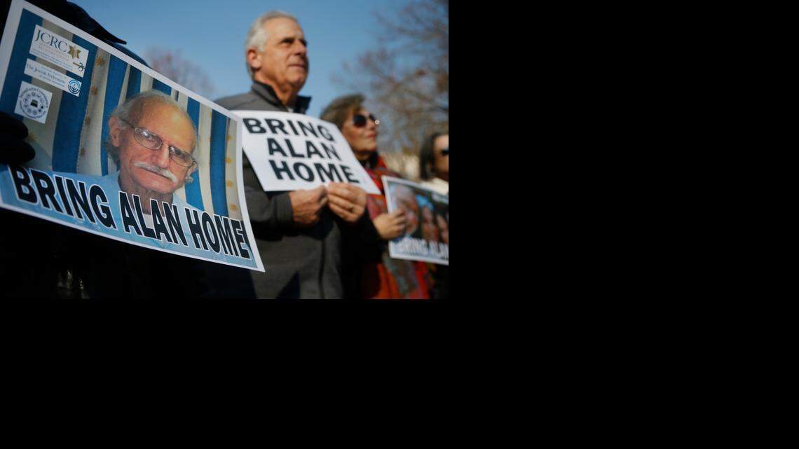 
In this Dec. 3, 2013 file photo, supporters of Alan Gross, on poster at left, mark his fourth year in a Cuban prison with a protest in Lafayette Park, across from the White House in Washington, D.C. 
