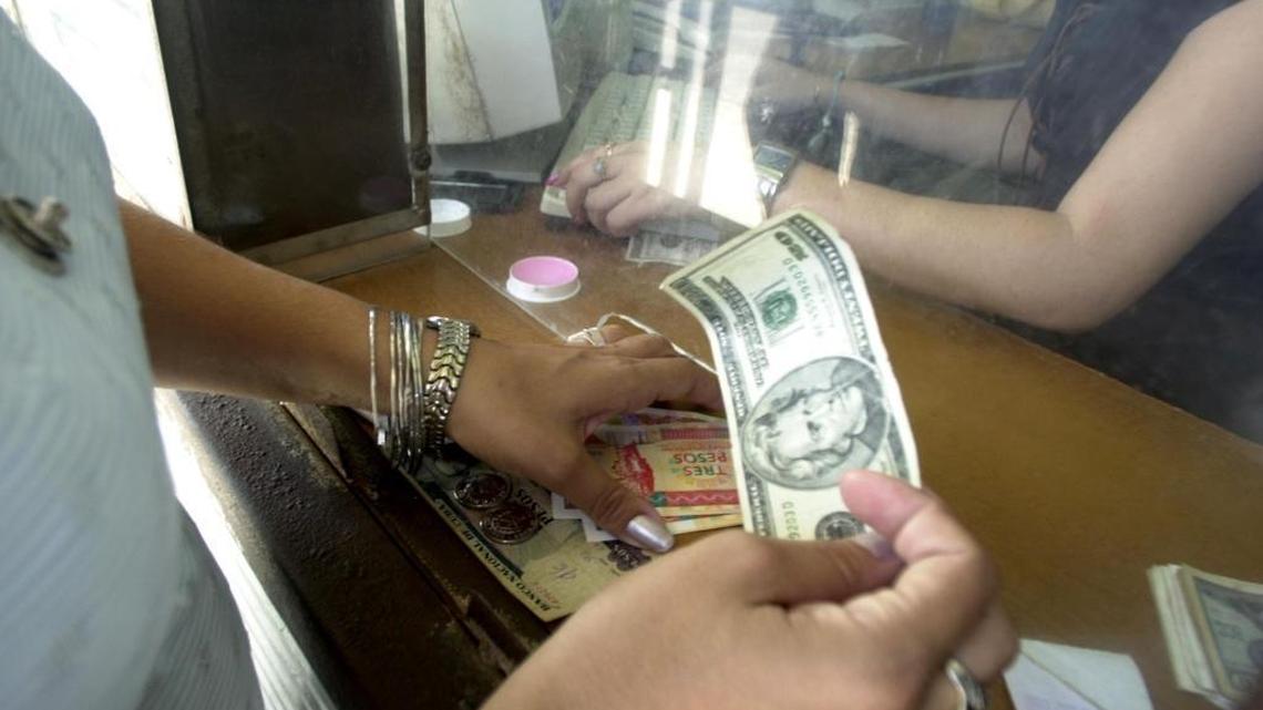 A woman exchanges U.S. dollars for Cuban pesos in Havana. Remittances from the United States have become the lifeblood of many Cuban families.