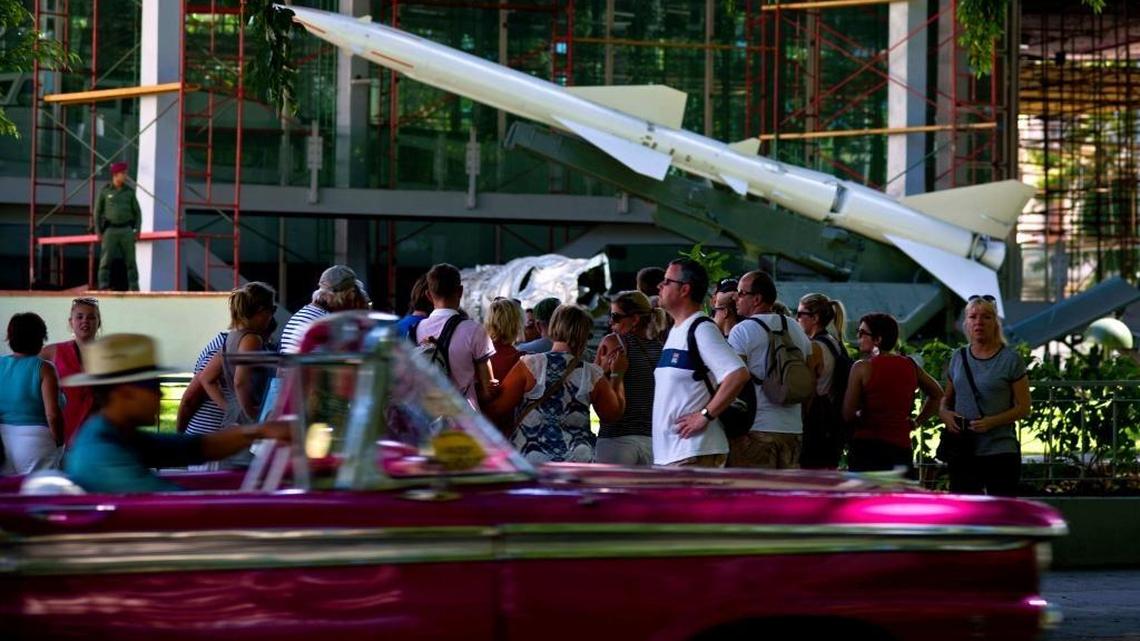 Tourists listen to a tour guide near an anti-aircraft missile on exhibit at the Revolution Museum, in Havana, Cuba. Photo/Ramon Espinosa)