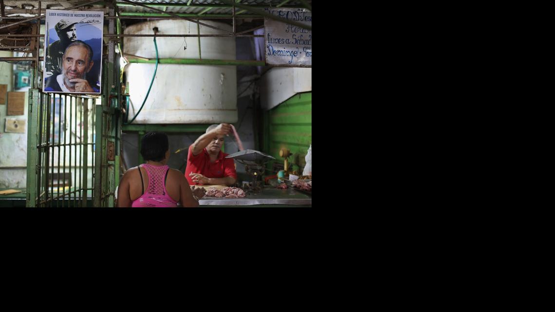 
HAVANA, CUBA - JANUARY 24: Under a poster of former Cuban President Fidel Castro, a woman buys pork in an open air market in the Jesus Maria neighborhood of Habana Vieja January 24, 2015 in Havana, Cuba. After the Cuban government expanded the list of accepted private small businesses between 2010 and 2012, about 1 million people, 20 percent of the Cuban workforce, can now be classified as wholly in the private sector. Diplomats from the United States and Cuba held historic talks this week that could restore diplomatic ties and mark the end of more than 50 years of of Cold War-era hostility between the two countries. 
