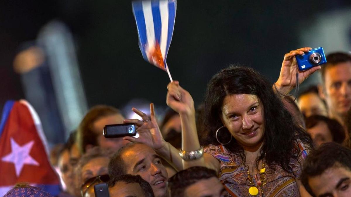In this file photo, a Cuban woman waves a flag of her country during a concert of Silvio Rodriguez in Havana, Cuba.