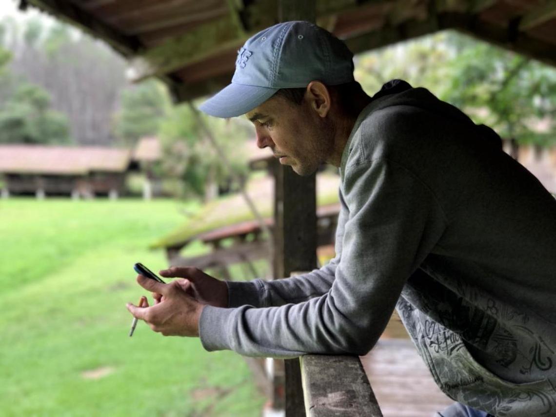 Liuber Pérez Expósito spends a lot of time on his cell phone with family in Cuba while he waits at a camp in Gualaca, Panama for a decision on his fate.