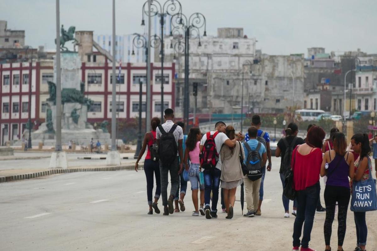 Students walk down the Malecón boulevard in Havana in late September 2017. It was free of traffic for three weeks due to continued cleanup and repair efforts following Hurricane Irma.