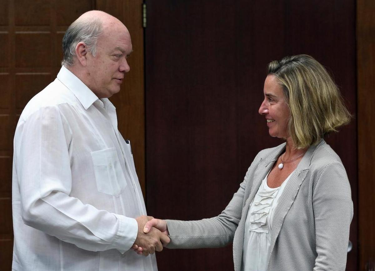 European Union High Representative Federica Mogherini, right, shakes hands with Cuba's Foreign Trade Minister Rodrigo Malmierca during a photo opportunity on the sidelines of their meeting in Havana on Jan. 3, 2018.