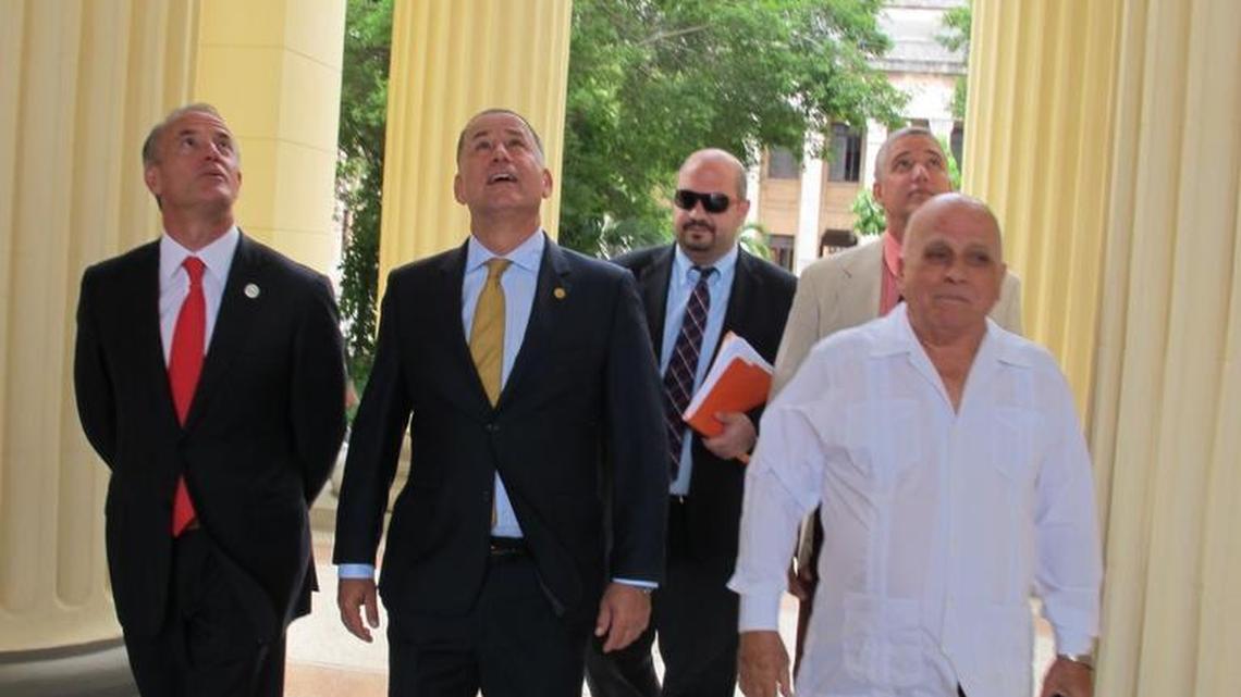 Miami Beach Mayor Philip Levine, in yellow tie, looks up at a restored ceiling at the University of Havana. Commissioner Ricky Arriola stands to his left. The politicians got a tour Wednesdayfrom Vice-Provost Francisco González, right.