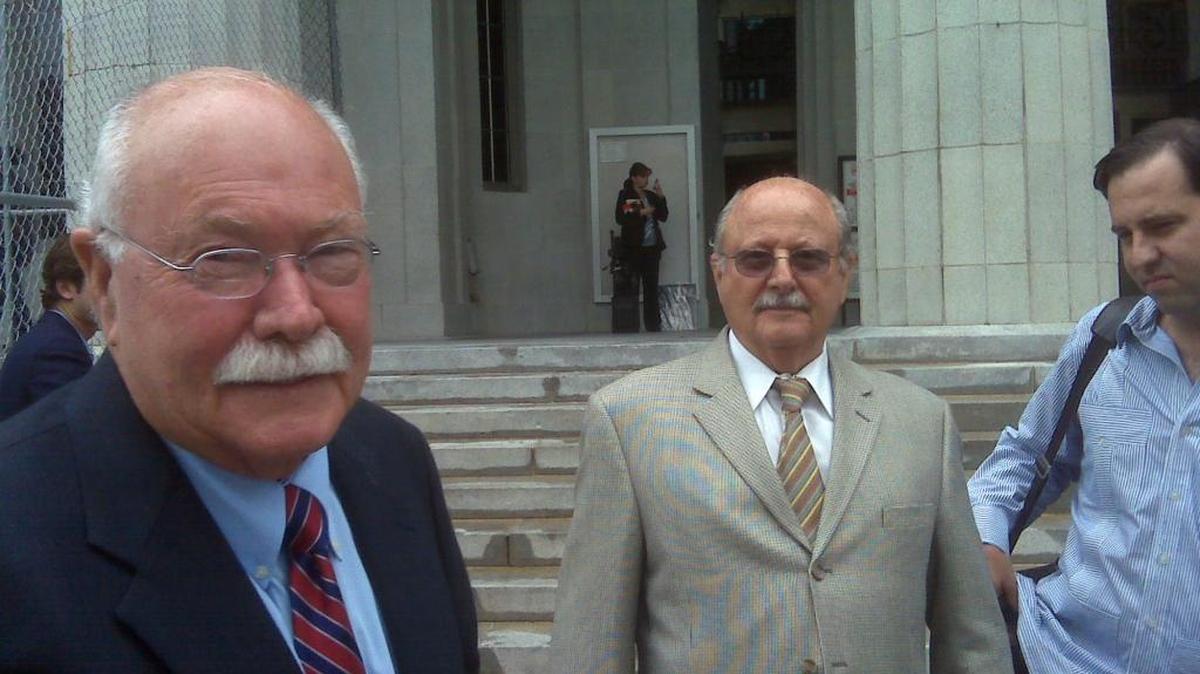 Gustavo and Alfredo Villoldo celebrate outside the Miami-Dade courthouse following the awarding by Miami-Dade Circuit Judge Peter Adrien of a $1 billion verdict in their favor against the Cuban government.