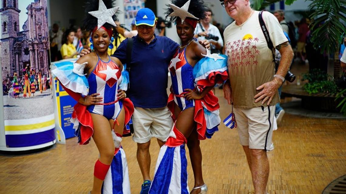Two passengers from the Adonia cruise ship pose with Cuban dancers in Havana on May 2, 2016.