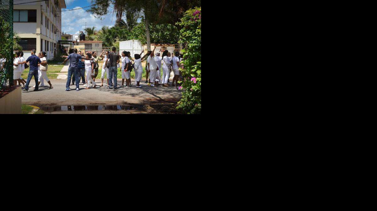 
Sonia Garro Alfonso, a Cuban activist who has been in post-trial detention since 2012, is a member of the Ladies in White. In a separate incident, members of the group are shown being arrested in Havana during a July 13, 2014 march.

