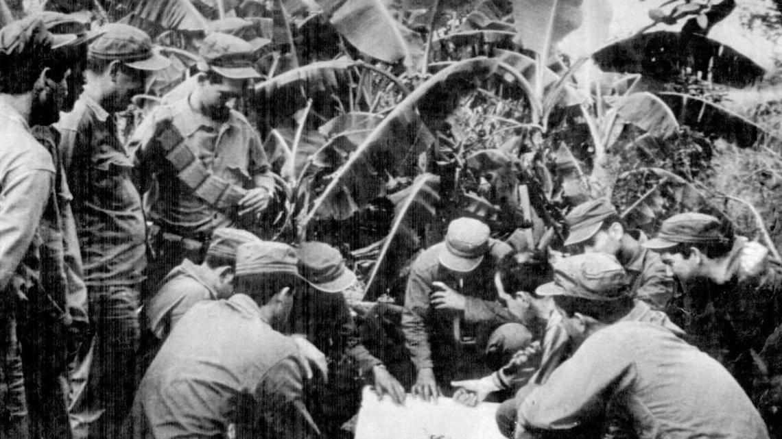 Cuban exiles, members of the anti-Castro forces, look over a map during training a few days prior to the Bay of Pigs invasion.