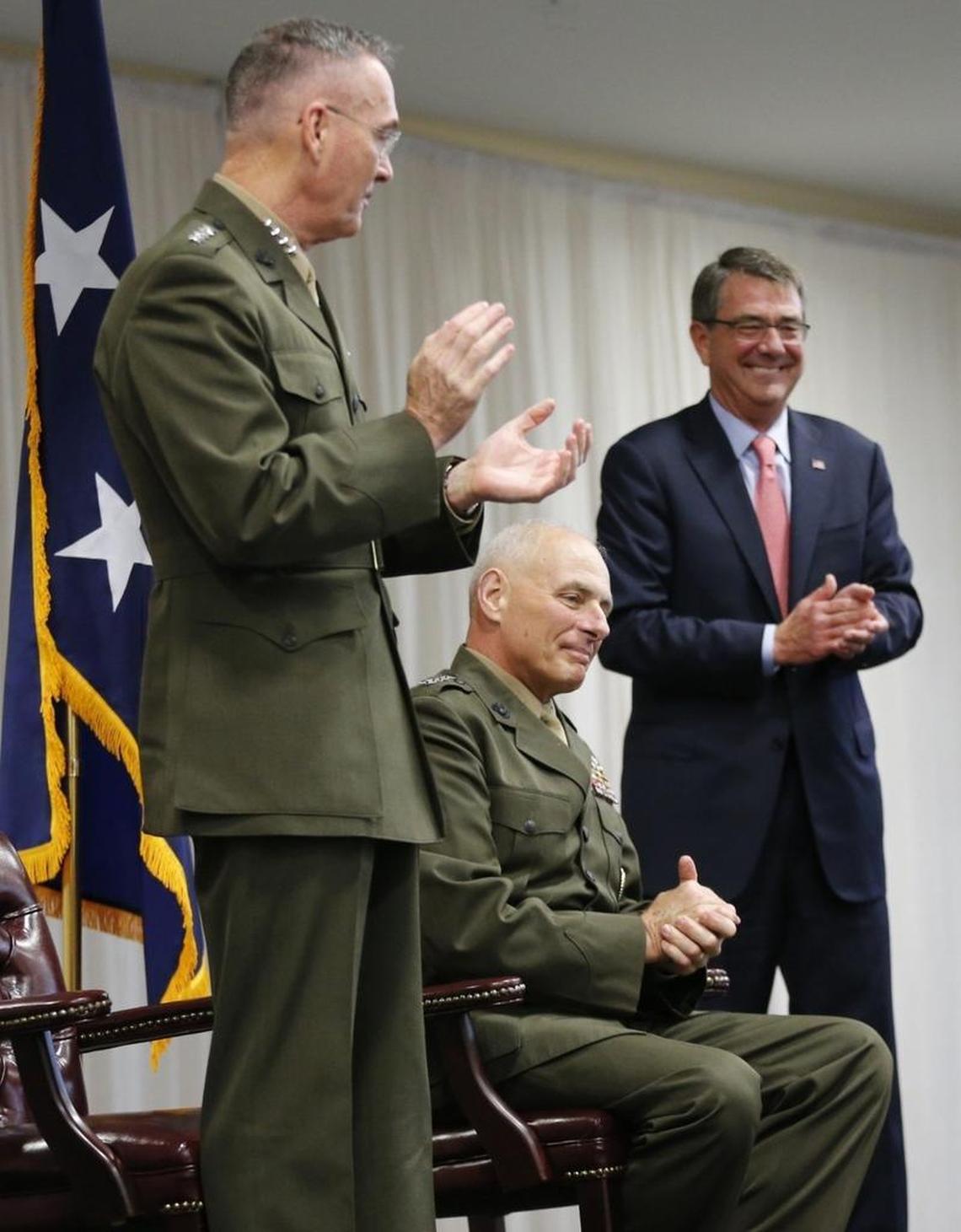 The Chairman of the Joints Chiefs of Staff, Marine Gen. Joseph Dunford, left, and Secretary of Defense Ash Carter, right, congratulate Marine Gen. John F. Kelly, center, as he stepped down as commander of the U.S. Southern Command on Jan. 14, 2016.