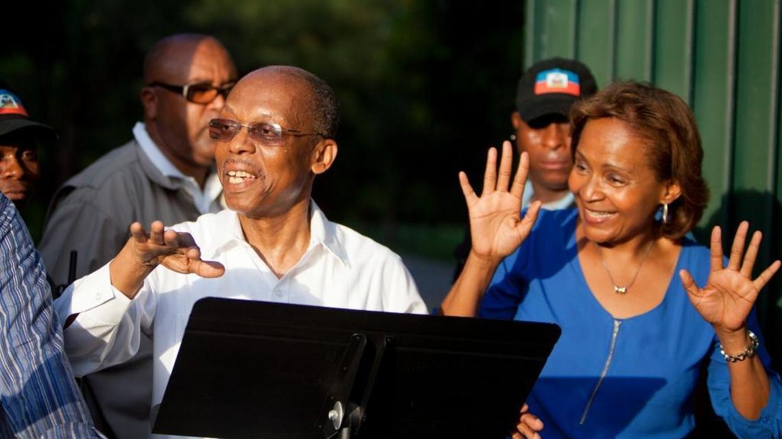 
Haiti's former President Jean Bertrand Aristide, left, talks to the crowd after he urged supporters to vote for presidential candidate Maryse Narcisse, right, of the Fanmi Lavalas political party, in Port-au-Prince, Haiti, Wednesday Sept. 30, 2015. Aristide's public endorsement could be a boon for Narcisse, who is polling well below front-runner Jude Celestin. During the last election cycle about five years ago, the party was barred from the ballot. 
