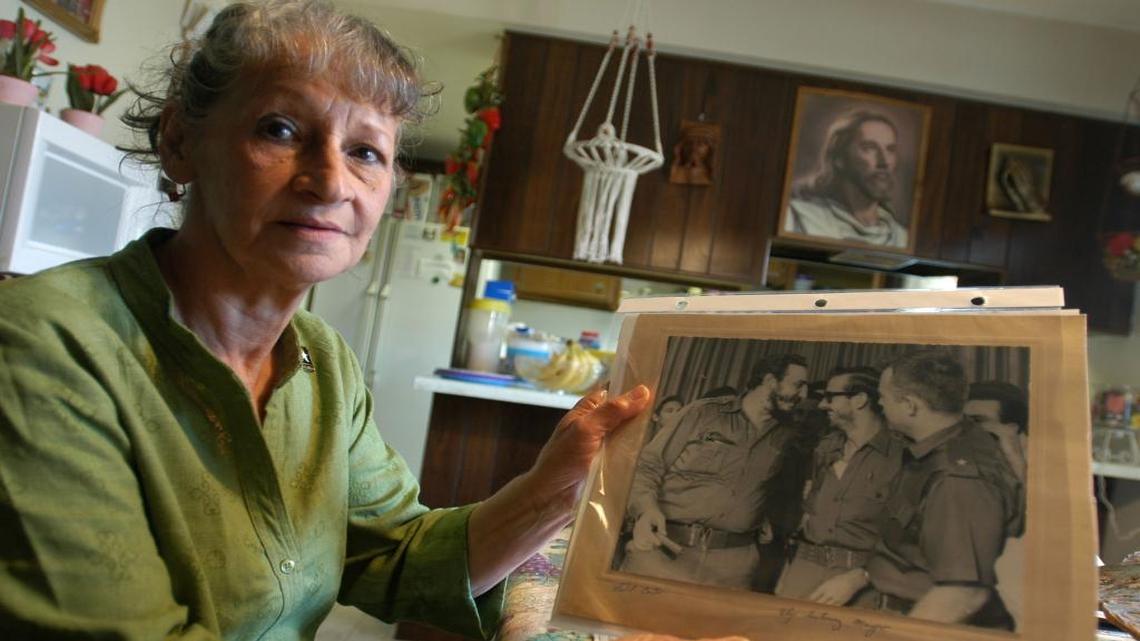 Olga Morgan Goodwin is seen holding a photograph of her late husband, William Morgan, right, along with Cuban dictator Fidel Castro, left, at her home in Toledo, Ohio.