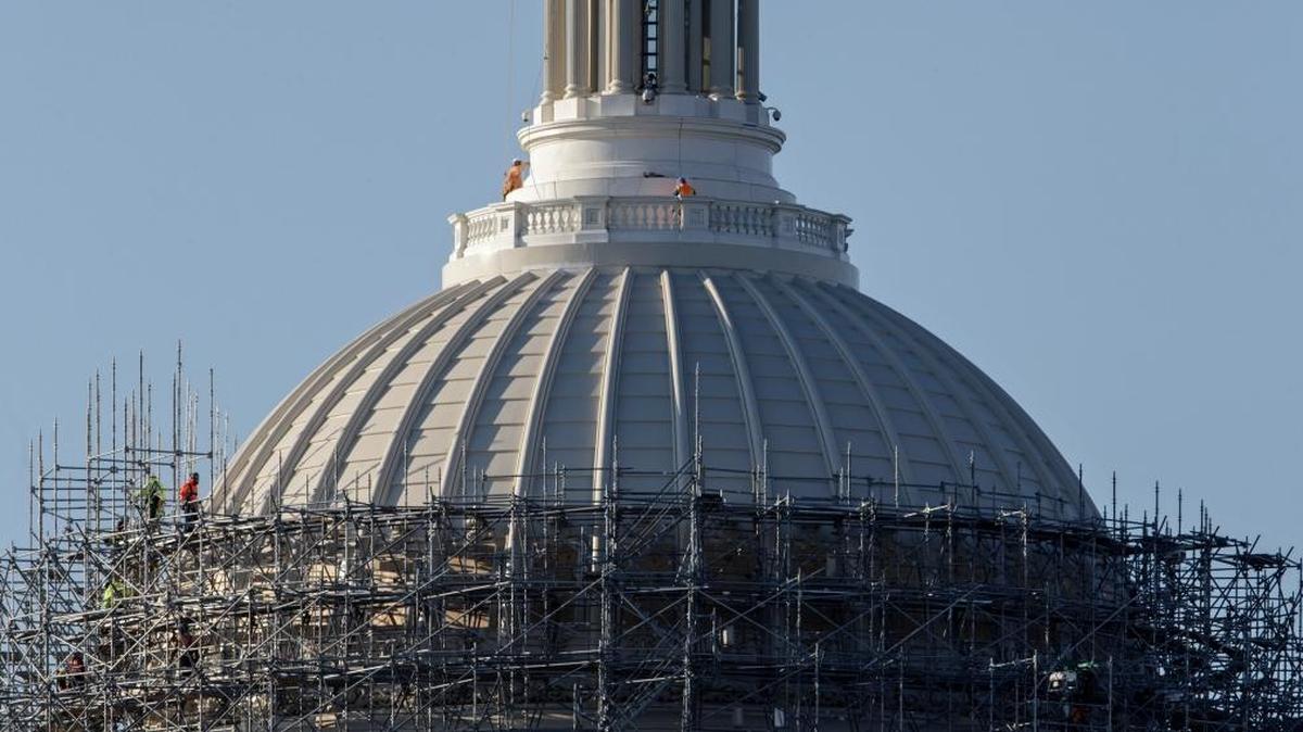 Workmen take apart the scaffolding that has shrouded the Capitol Dome for two years as it received a multi-million dollar renovation to repair cracks, remove lead paint and restore the structure to its original splendor, Monday, March 21, 2016, on Capitol Hill in Washington.