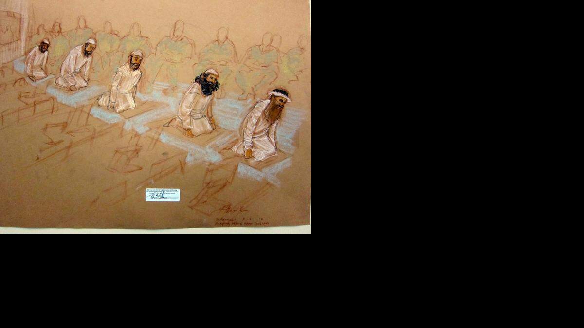 
Left to right: Mustafa al Hawsawi, Ammar al Baluchi, Ramzi bin al Shibh, Walid Bin Attash and Khalik Sheik Mohammad, pray at their arraignment Saturday, May 5, 2012 at the U.S. Navy base at Guantánamo. A U.S. military security official examined this sketch and approved its release.
