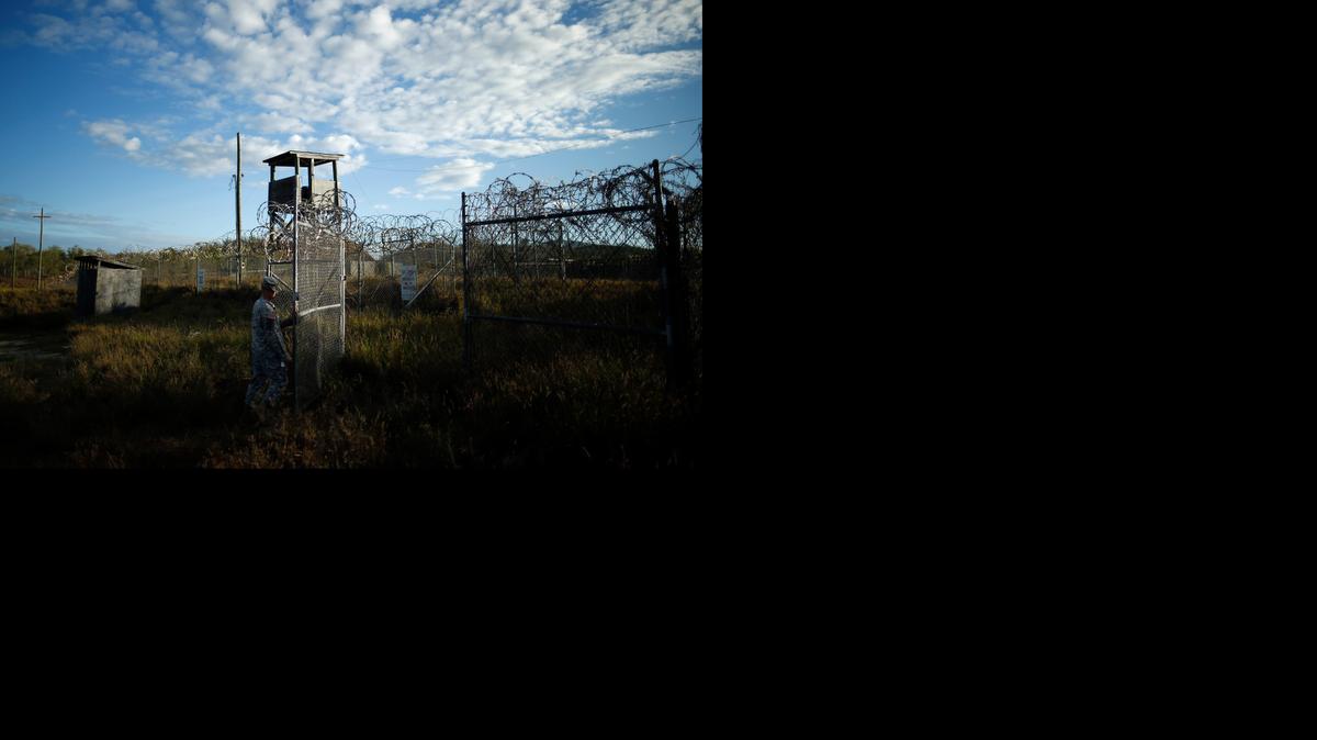 
In this Nov. 13, 2013, file photo reviewed by the U.S. military, a soldier closes the gate at the now abandoned Camp X-Ray, which was used as the first detention facility for suspected militants who were captured after the Sept. 11 attacks.

