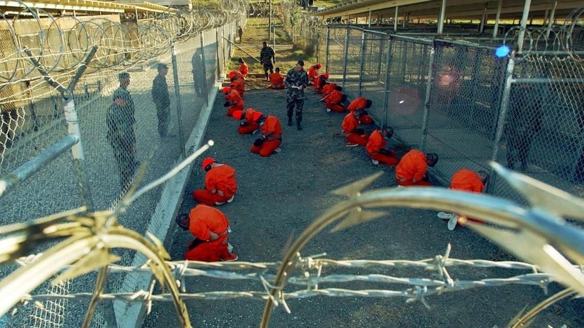 The now-iconic image of the first detainees to land at Guantánamo Bay, Cuba — capturing a moment of men on their knees in orange jumpsuits behind barbed wire fences. The Pentagon has built more solid prison space since then. As of Jan. 5, 2017, just two of those first 20 men were still at the U.S. Navy base prison.