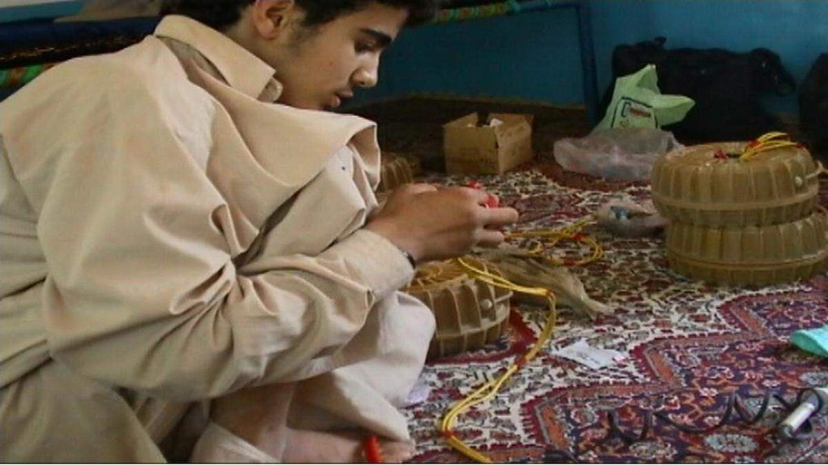 
Omar Khadr, at age 15, in the summer of 2002, learning to build land mines in Afghanistan, in a photo used as an exhibit by a war court prosecutor at the U.S. Navy base at Guantánamo Bay, Cuba. The prosecution asked a jury to sentence Khadr, now 24, to 25 years. The jury instead gave him 40 but a plea agreement limited his sentence to eight years.

