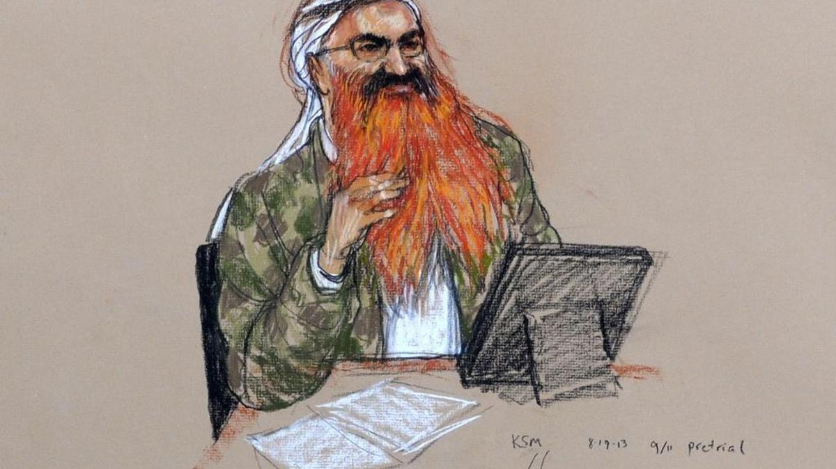 
In this sketch by courtroom artist Janet Hamlin and approved for release by a Pentagon contractor, Khalid Sheik Mohammed, with his gray beard streaked with reddish-orange dye, attends an Aug. 19, 2013 pretrial hearing at the U.S. Navy Base in Guantánamo Bay, Cuba.
